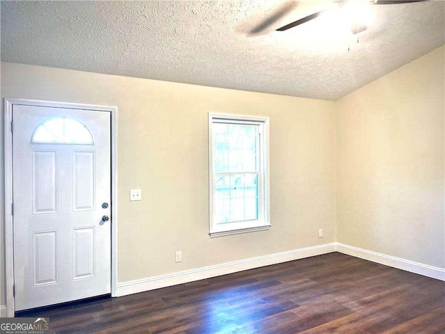 entryway featuring dark hardwood / wood-style floors, ceiling fan, and a textured ceiling