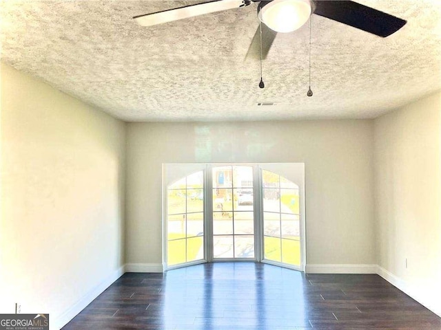 unfurnished room with ceiling fan and dark hardwood / wood-style flooring