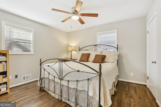 bedroom featuring ceiling fan and dark hardwood / wood-style floors