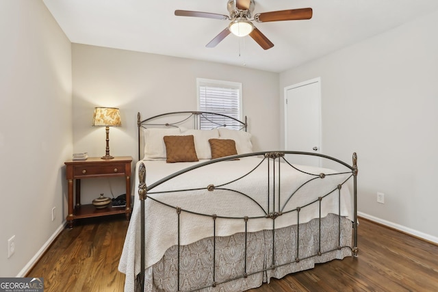 bedroom with ceiling fan and dark wood-type flooring