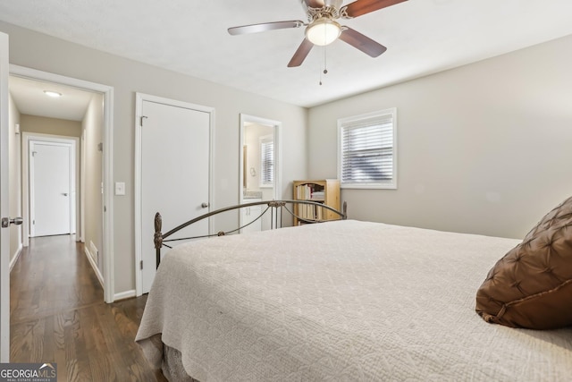 bedroom with ceiling fan and dark wood-type flooring