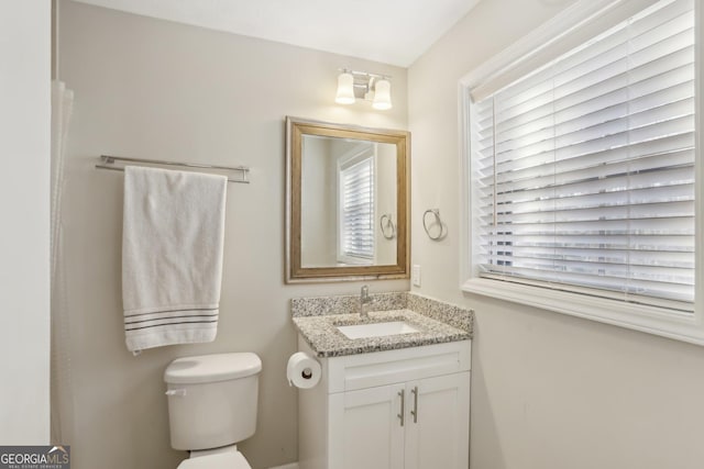 bathroom featuring vanity and toilet