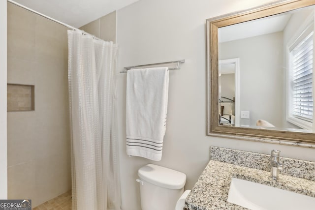 bathroom with a wealth of natural light, toilet, vanity, and a shower with shower curtain