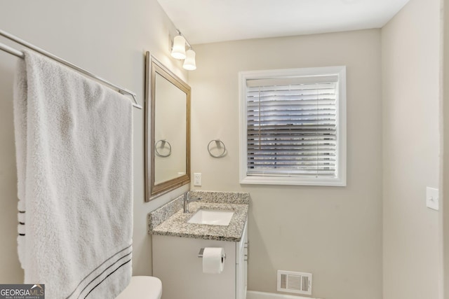 bathroom featuring vanity and toilet