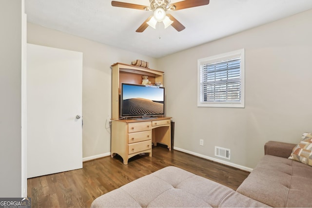 living room featuring dark hardwood / wood-style floors and ceiling fan