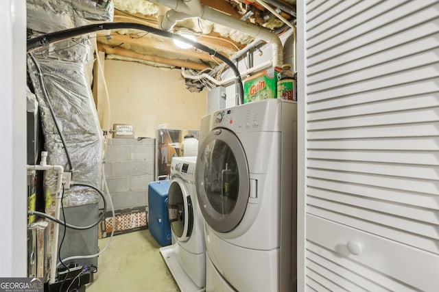 washroom with washing machine and clothes dryer