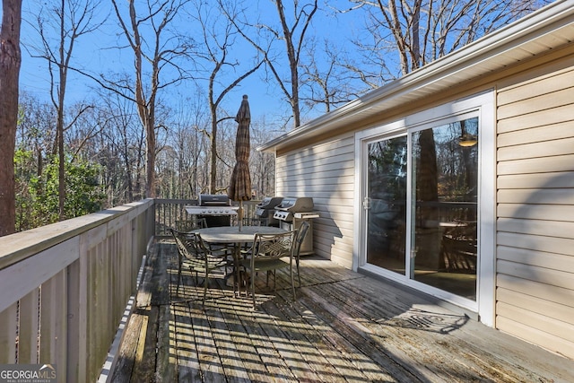 wooden terrace with a grill