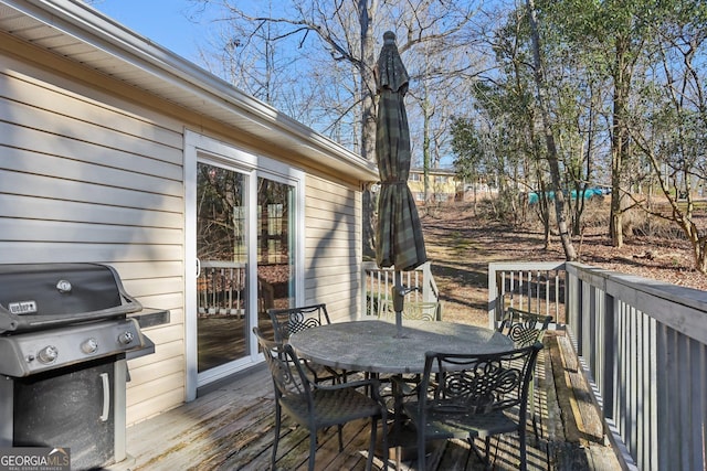 wooden terrace featuring a grill