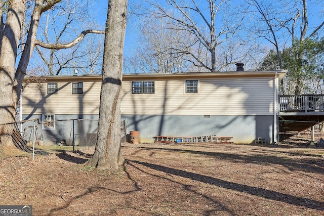 rear view of property with a wooden deck