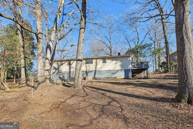 rear view of property with a wooden deck