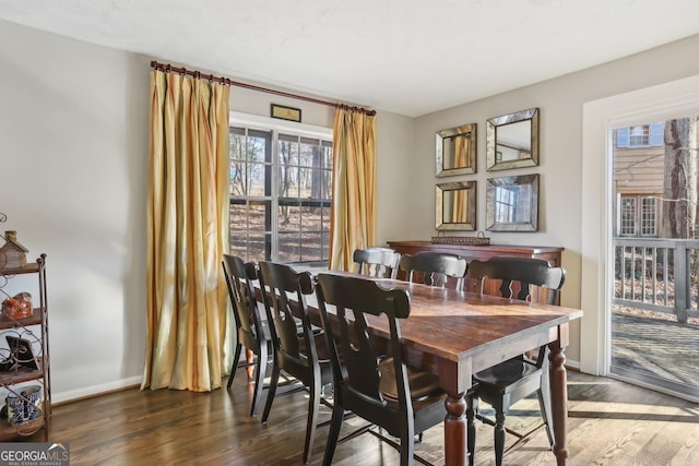 dining space with dark hardwood / wood-style flooring and plenty of natural light