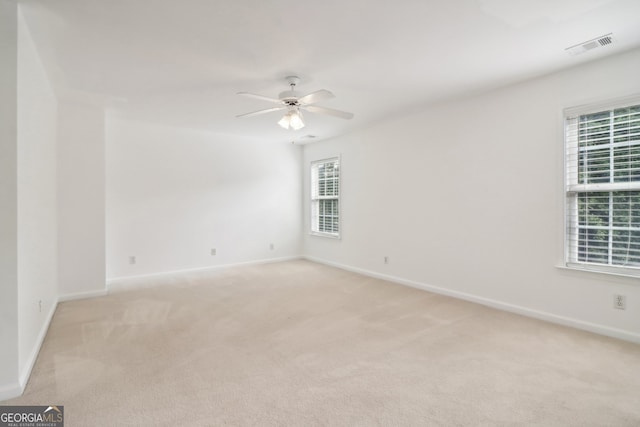 unfurnished room with ceiling fan and light colored carpet