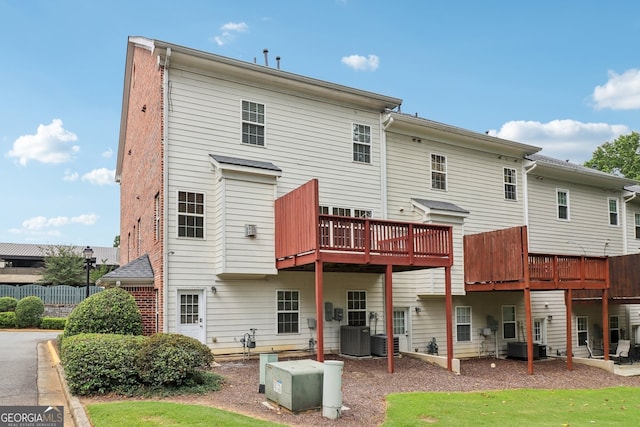 back of house featuring central AC and a deck