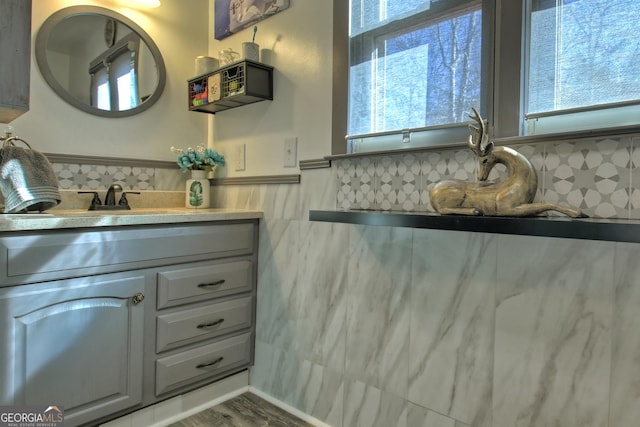 bathroom with hardwood / wood-style floors, vanity, and a healthy amount of sunlight