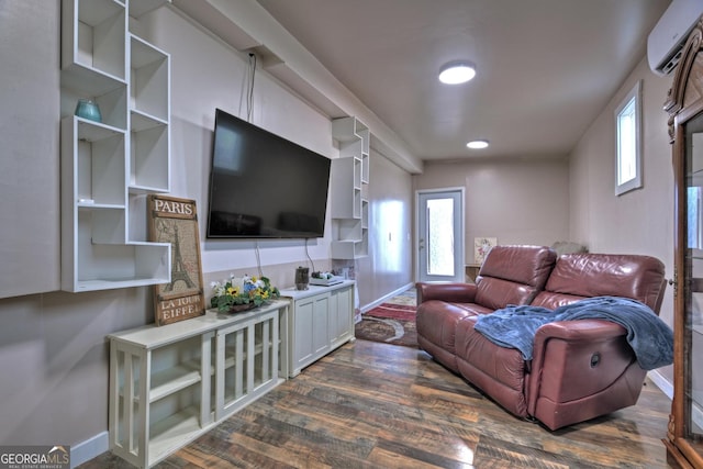 living room featuring dark hardwood / wood-style flooring and an AC wall unit