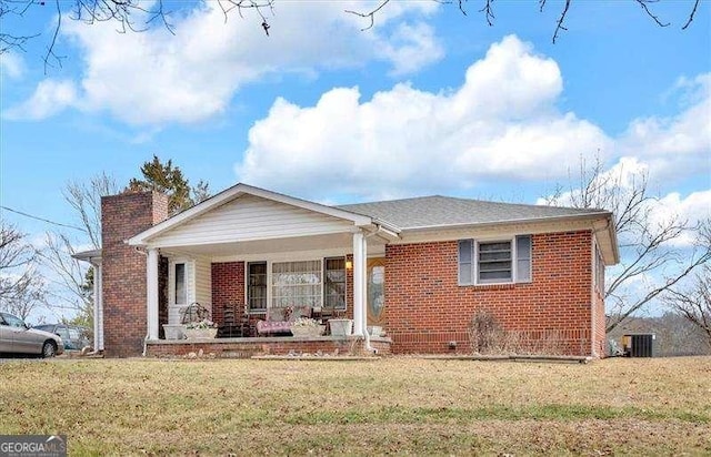 view of front facade with central AC, a front lawn, and a porch