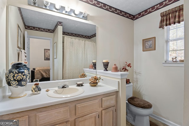 3700 Mays Xing SW, Atlanta, GA 30331 - ensuite bathroom featuring toilet, vanity, a textured ceiling, and baseboards