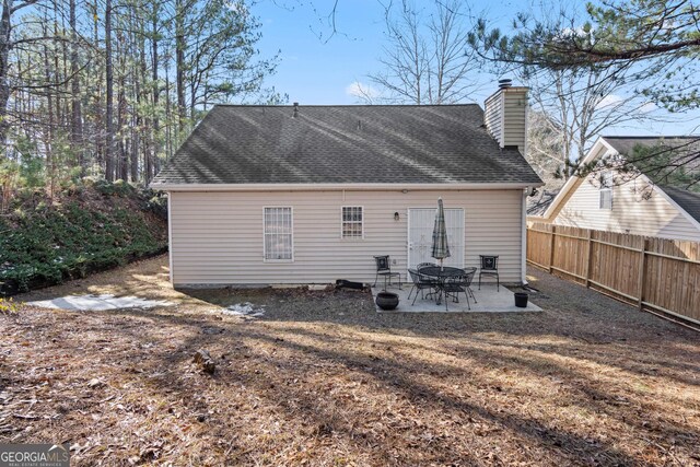 3700 Mays Xing SW, Atlanta, GA 30331 - rear view of house with fence, a patio, a chimney, and a shingled roof