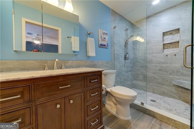 bathroom with vanity, toilet, and an enclosed shower