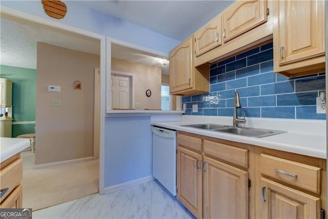 kitchen featuring backsplash, dishwasher, light brown cabinets, and sink