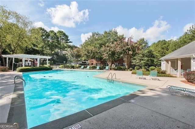 view of swimming pool featuring a pergola and a patio