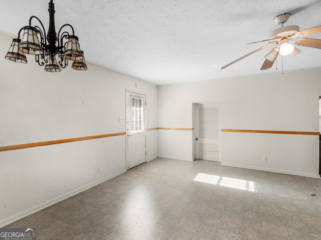 empty room featuring a textured ceiling and ceiling fan