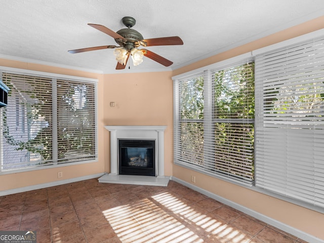 unfurnished living room with crown molding, a textured ceiling, tile patterned floors, and ceiling fan