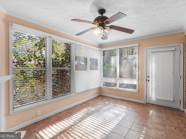 unfurnished sunroom with ceiling fan