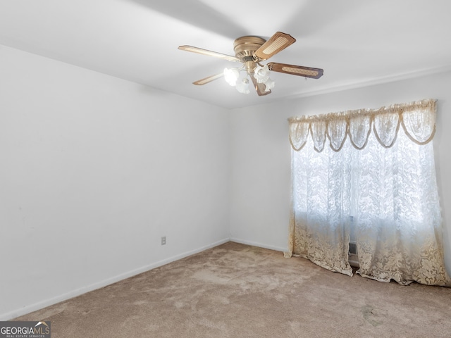 empty room featuring ceiling fan and carpet flooring