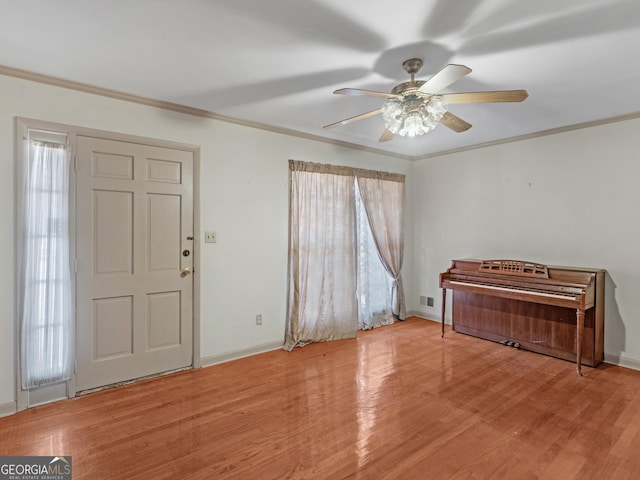 foyer featuring hardwood / wood-style floors and crown molding