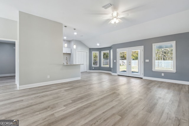 unfurnished living room featuring ceiling fan, french doors, sink, light hardwood / wood-style flooring, and lofted ceiling