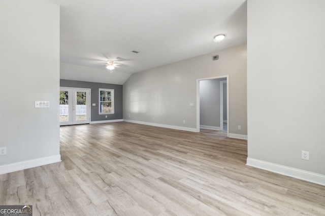 unfurnished room featuring ceiling fan, french doors, light hardwood / wood-style floors, and vaulted ceiling