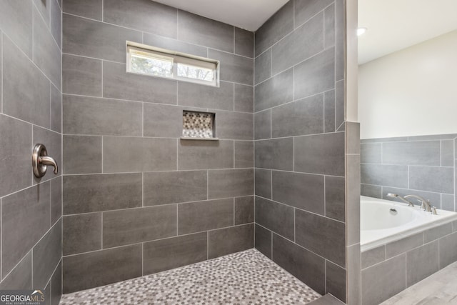 bathroom featuring shower with separate bathtub