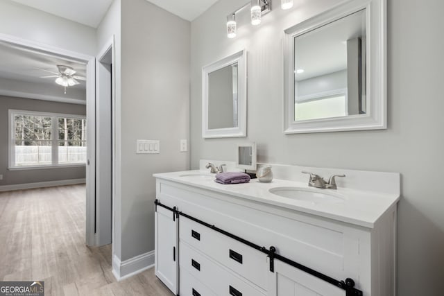 bathroom with vanity, hardwood / wood-style flooring, and ceiling fan