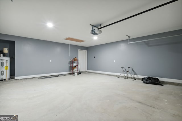 garage with electric water heater and a garage door opener