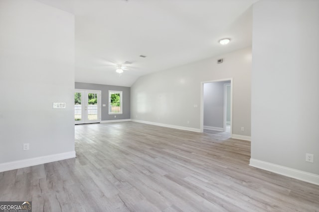 spare room with ceiling fan, light wood-type flooring, and lofted ceiling