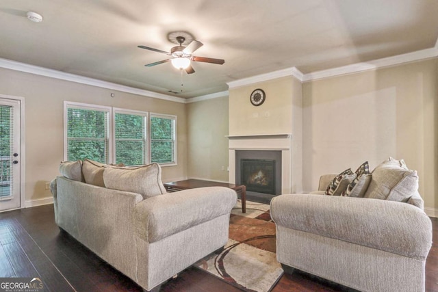 living room with dark hardwood / wood-style floors, ceiling fan, and crown molding