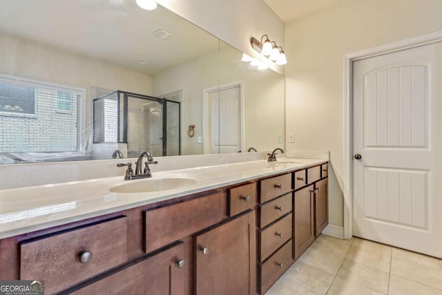 bathroom with tile patterned floors, vanity, and a shower with shower door