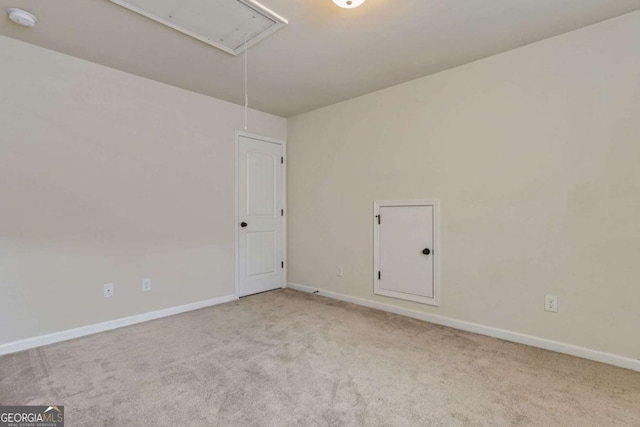 unfurnished room featuring light carpet