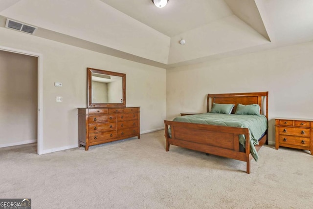 carpeted bedroom featuring a tray ceiling