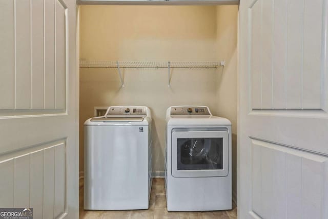 clothes washing area featuring washer and clothes dryer