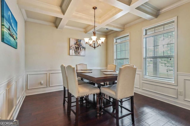 dining area with dark hardwood / wood-style floors, an inviting chandelier, and ornamental molding