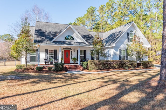 cape cod-style house featuring a porch and a front yard