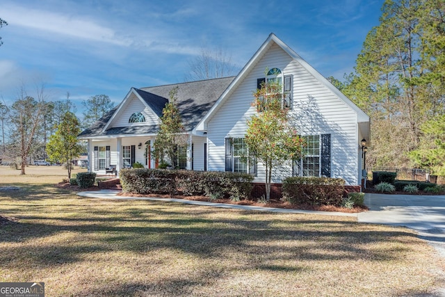 view of front of property with covered porch and a front lawn