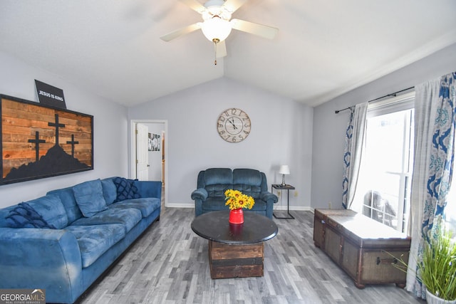 living room with lofted ceiling, ceiling fan, and light hardwood / wood-style floors