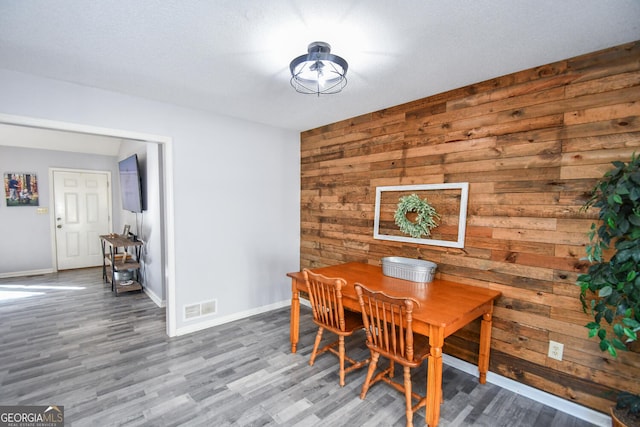 390 Apple Rdg Unit 2, Dawsonville, GA 30534 - dining room featuring wooden walls, wood finished floors, and baseboards