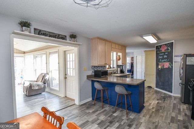 390 Apple Rdg Unit 2, Dawsonville, GA 30534 - kitchen with stainless steel appliances, dark wood-style floors, a peninsula, a sink, and a kitchen bar
