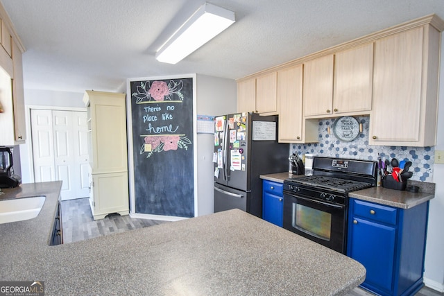 390 Apple Rdg Unit 2, Dawsonville, GA 30534 - kitchen featuring black gas range oven, freestanding refrigerator, blue cabinets, wood finished floors, and a textured ceiling