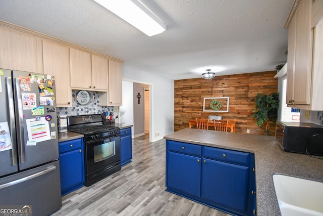 390 Apple Rdg Unit 2, Dawsonville, GA 30534 - kitchen featuring black appliances, blue cabinets, wooden walls, a peninsula, and a sink