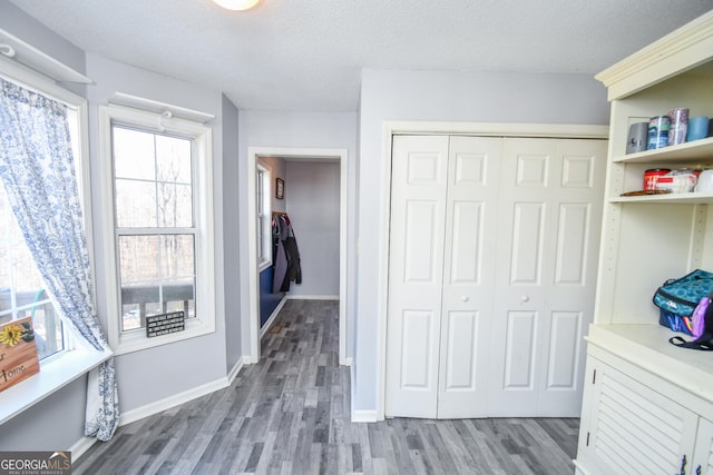 interior space featuring a closet, hardwood / wood-style floors, and a textured ceiling